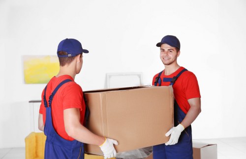 Professional movers packing and protecting furniture